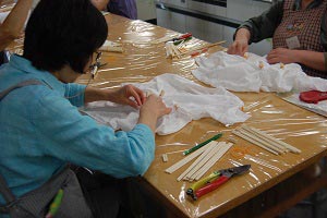 割り箸と輪ゴムで菊花絞りの作業の画像