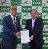 評価委員長から大学理事長へ評価結果を手渡している写真